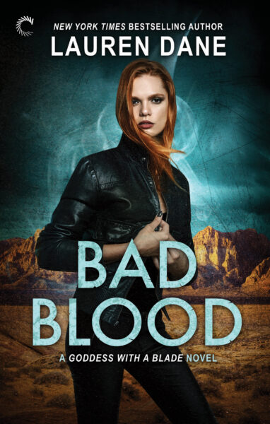 red headed white woman in a leather jacket standing with a desert background for Lauren Dane's Urban Fantasy novel, BAD BLOOD